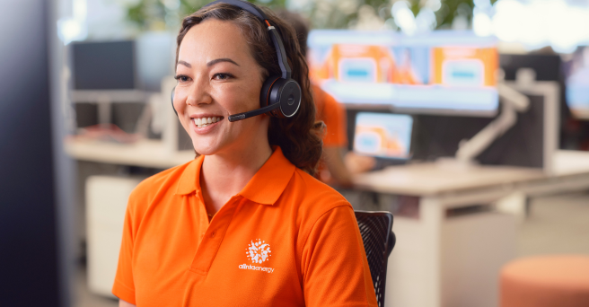 Alinta staff wearing headset and smiling