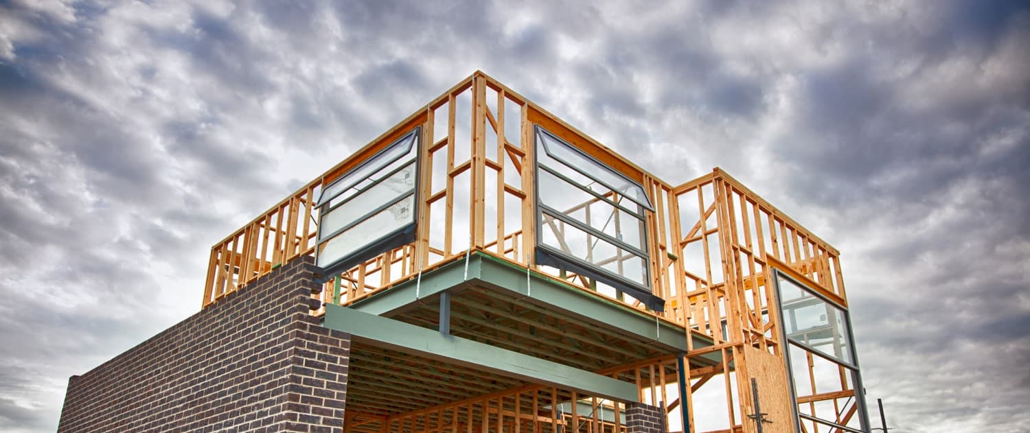 New house being built showing wooden frame and bricks